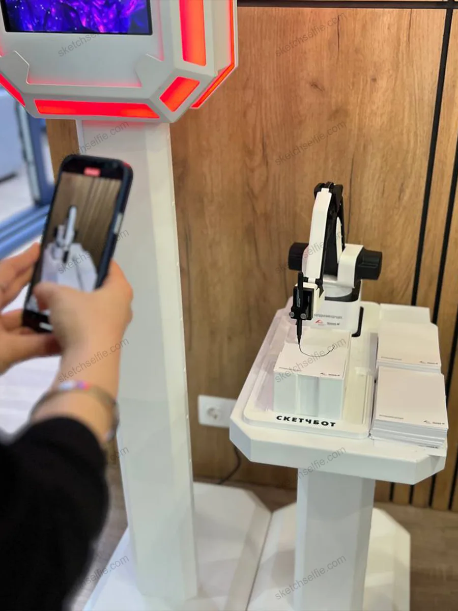 girl filming sketchbot drawing process